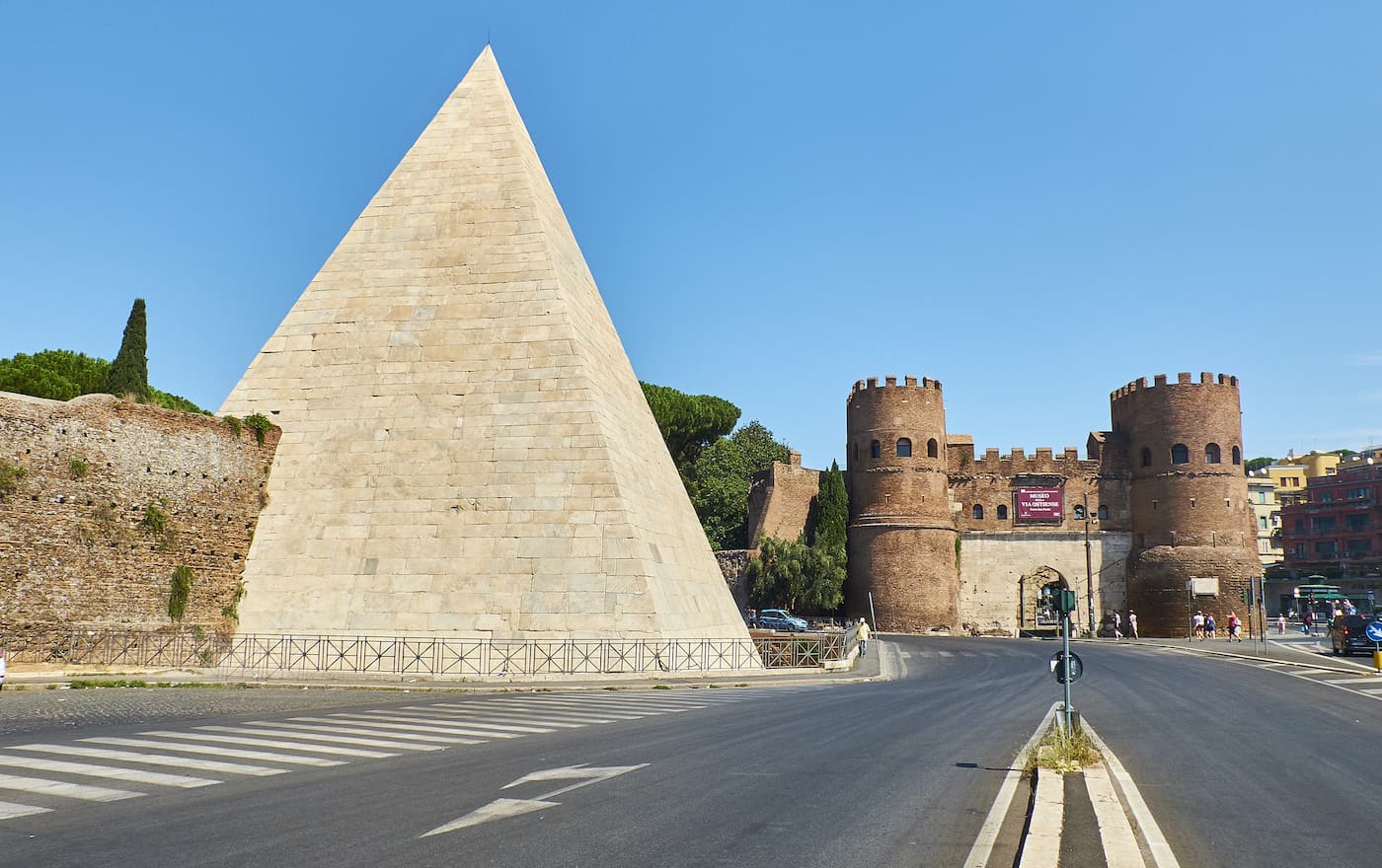  The Pyramid of Cestius and Porta San Paolo gate in background. View from Piazzale Ostiense square.