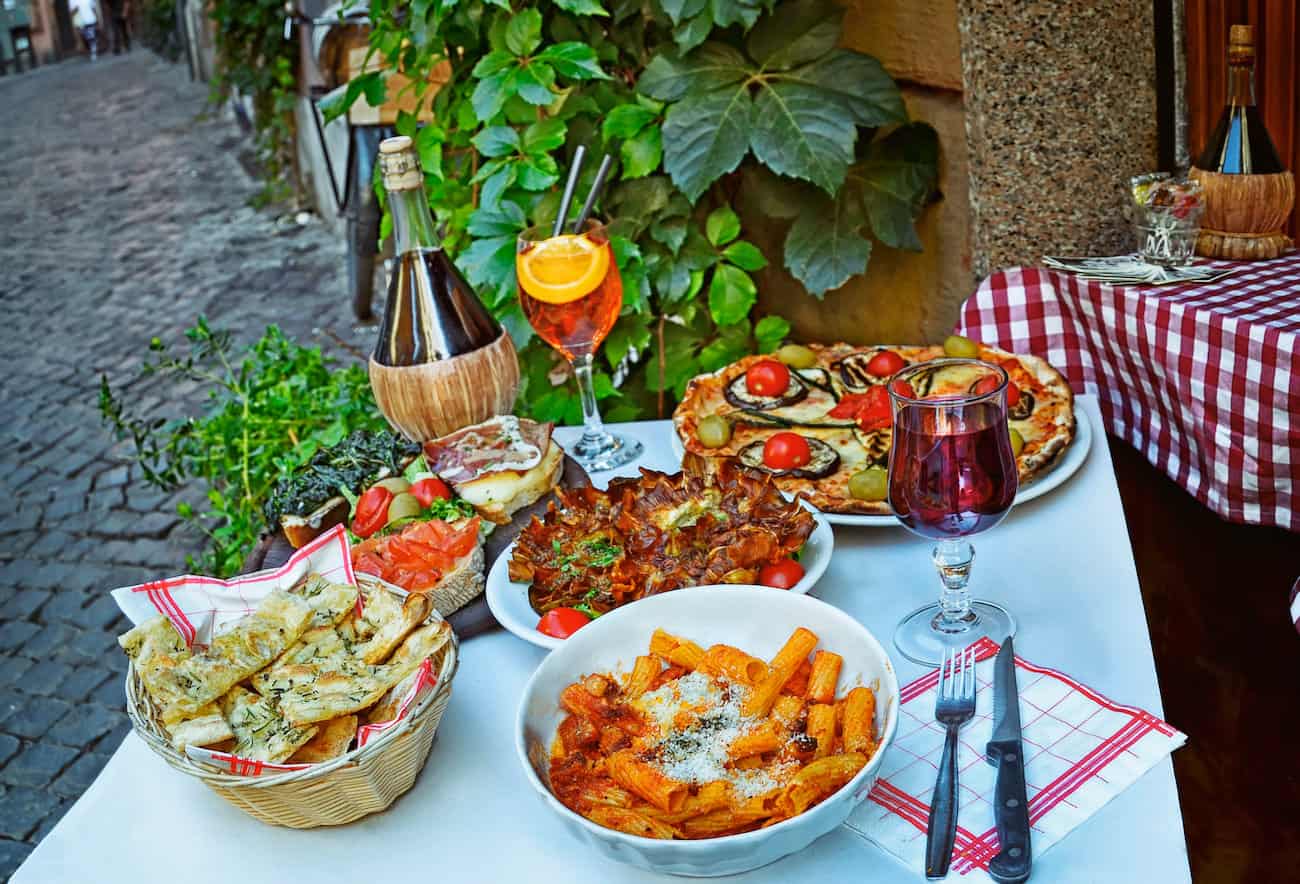 Italian food in outdoor restaurant in Trastevere district in Rome
